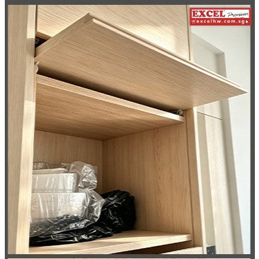 Cabinet flap door lifted open on a concealed slide system, revealing interior storage shelf