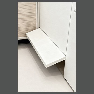 Close-up of a cabinet base panel tilted open by the automatic door opener